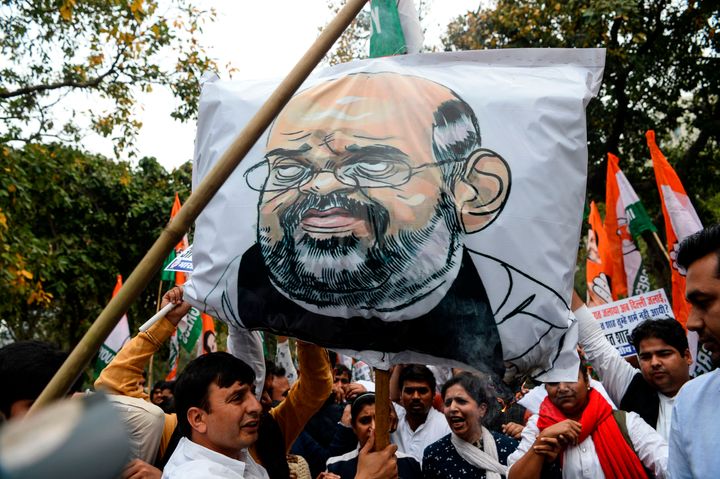 Youth Congress activists shout slogans next to an effigy of Home Minister Amit Shah during a protest demanding his resignation and the registration of a FIRs against BJP leaders Kapil Mishra, Anurag Thakur and Parvesh Verma for hate speeches, near the Parliament in New Delhi on March 2, 2020. 