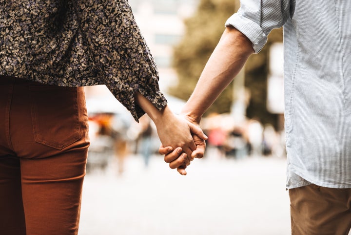 rear view of a couple walking on the street