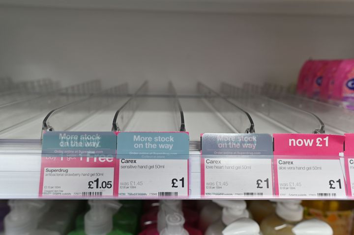 Empty shelves where hand sanitiser gels have sold out in a high street pharmacy in London 