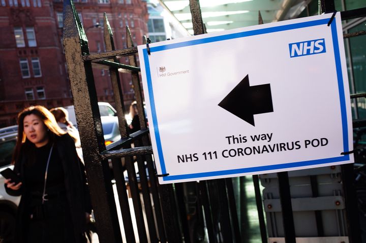 A sign for a Covid-19 'coronavirus pod' isolation unit fixed to railings outside University College Hospital in London