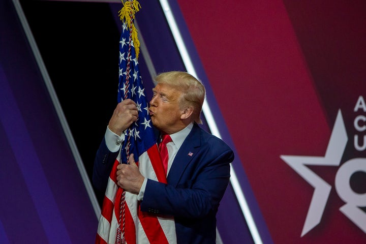 Trump kisses the U.S. flag at the annual Conservative Political Action Conference in National Harbor, Maryland, on Feb. 29, 2020.