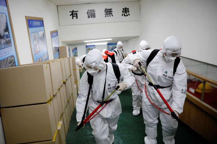 South Korean soldiers wearing protective gear sanitize inside the facility of a city hall after the rapid rise in confirmed cases of the novel coronavirus disease of (COVID-19) in Daegu, southeast of the capital Seoul, South Korea, March 2.