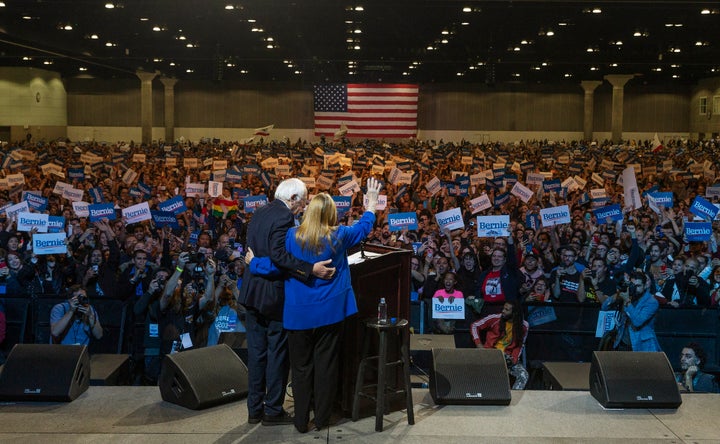 Jane Sanders and Sen. Bernie Sanders (I-Vt.) wave at supporters in Los Angeles on March 1, 2020. A sweeping victory in C