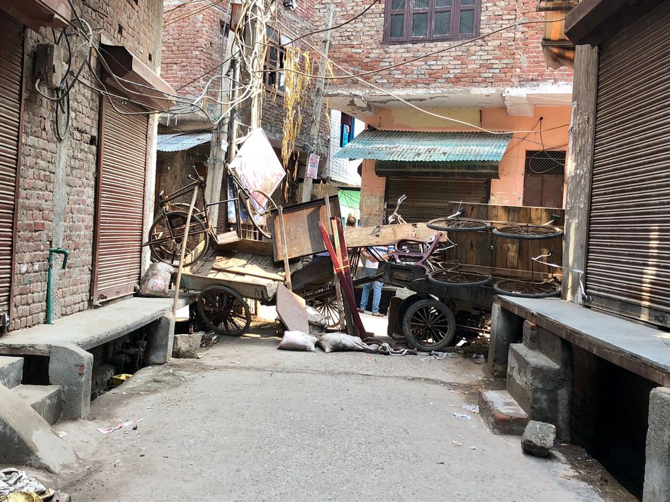 Barricades made of carts, furniture and bamboo sticks were still mounted a week after the worst rioting ended in Shiv Vihar, Delhi.