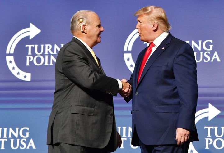 Rush Limbaugh shakes hands with U.S. President Donald Trump in West Palm Beach, Florida on Dec. 21, 2019. Limbaugh has pushed misinformation about the COVID-19 outbreak.