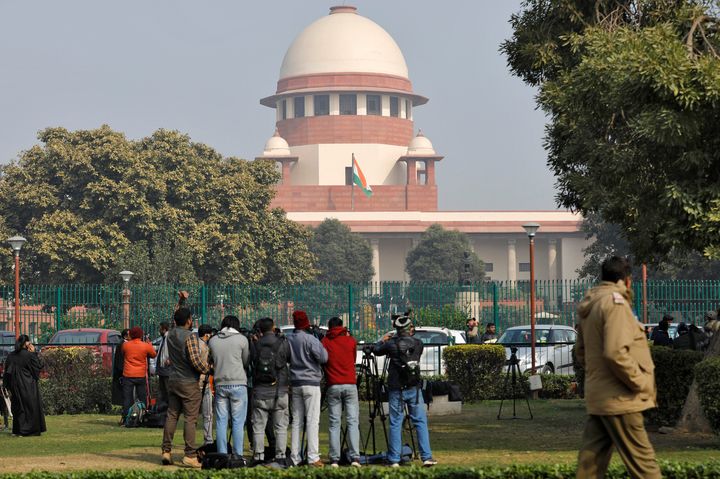 Television journalists are seen outside the premises of the Supreme Court in New Delhi.