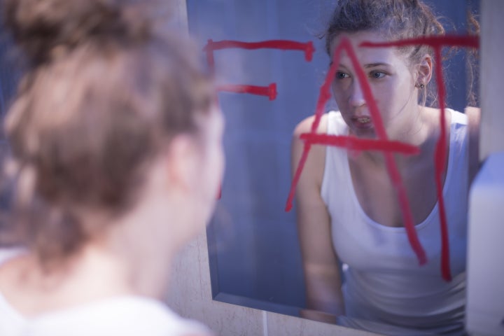 Fat red writing on mirror and teenage girl