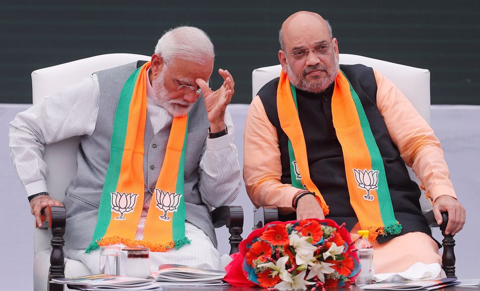 Prime Minister Narendra Modi (left) gestures as Home Minister Amit Shah looks on in this file photo.