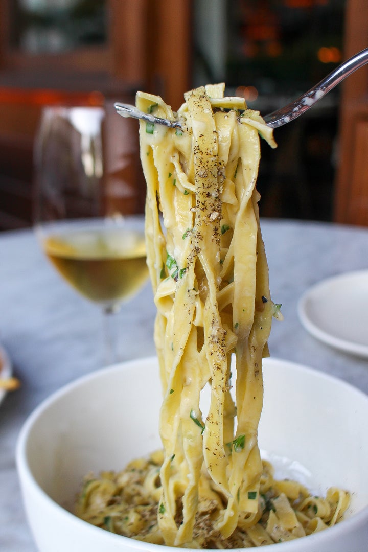 Garcia pulls a long bundles of pasta noodles.