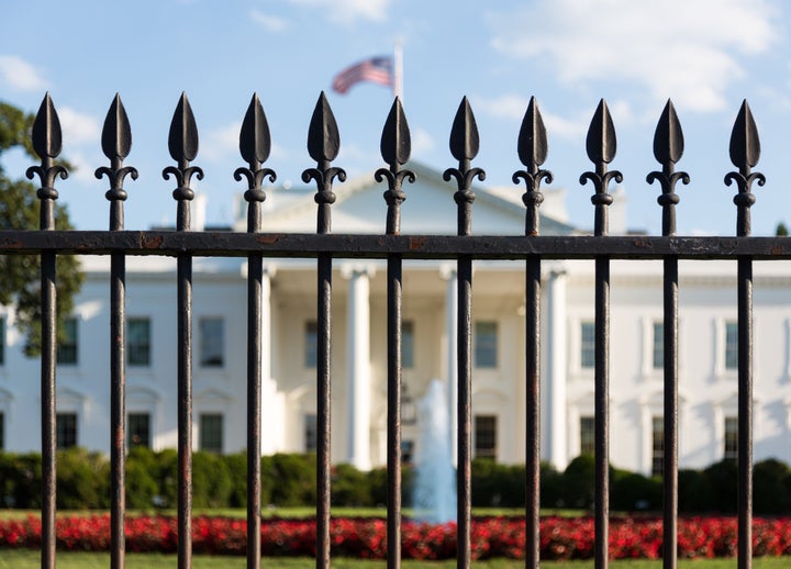 Main entrance of White House seen through railings at 1600 Pennsylvania Avenue in Washington, D.C.