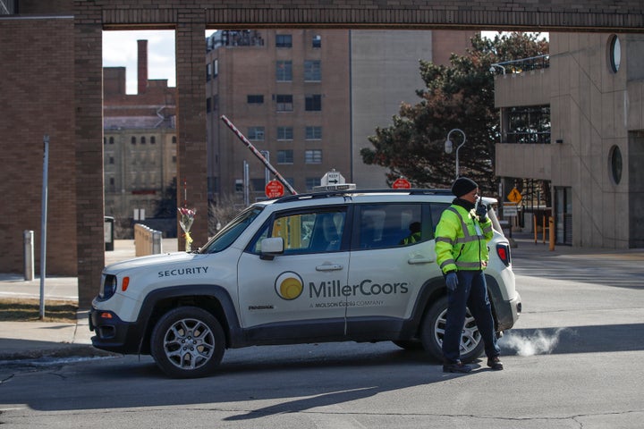 Security personnel patrol outside the Molson Coors campus on Feb. 27, a day after the deadly attack. 