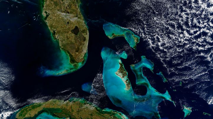 A satellite image of Florida (top left), the Bahamas (right) and Cuba (bottom left).