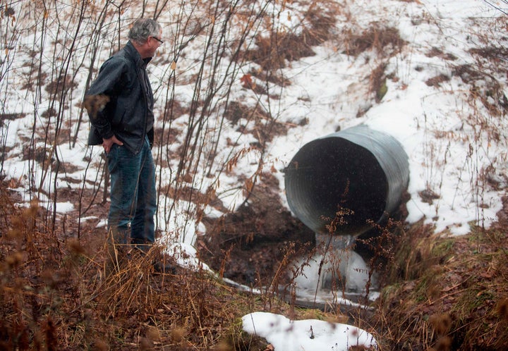 David Huff, chair of the zoning and planning commission for Osceola Township, stands before Chippewa Creek, shown flowing thr