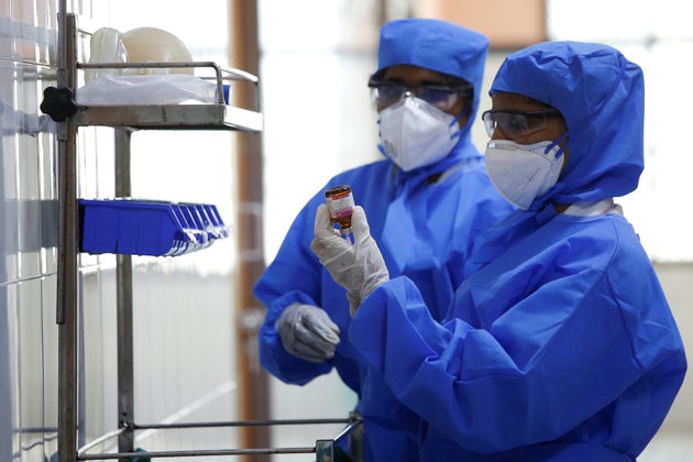 Medical staff with protective clothing are seen inside a ward specialised in receiving any person who...