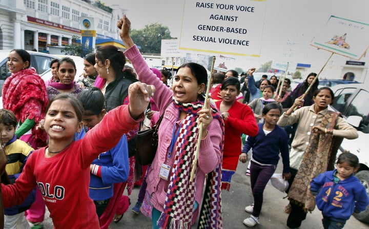 Girls and women raising slogans during a march organised by the Apne Aap Women Worldwide NGO in memory of the 2012 gang-rape victim on the eve of the anniversary of the attack, at Connaught Place on December 15, 2014 in New Delhi.