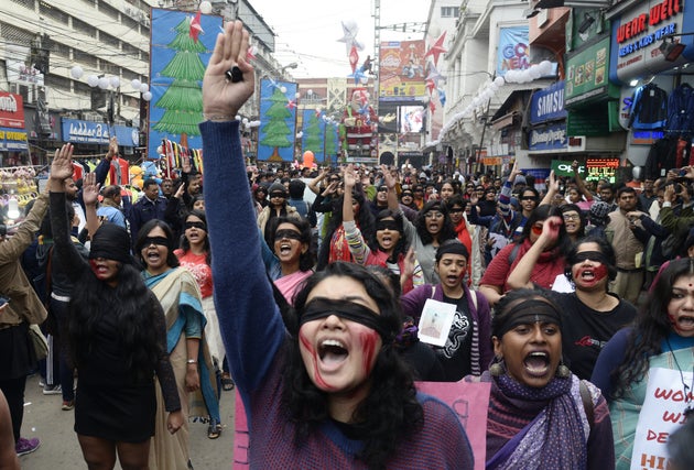 Women wear blindfolds during a demonstration to protest against violence against women in Kolkata, January...