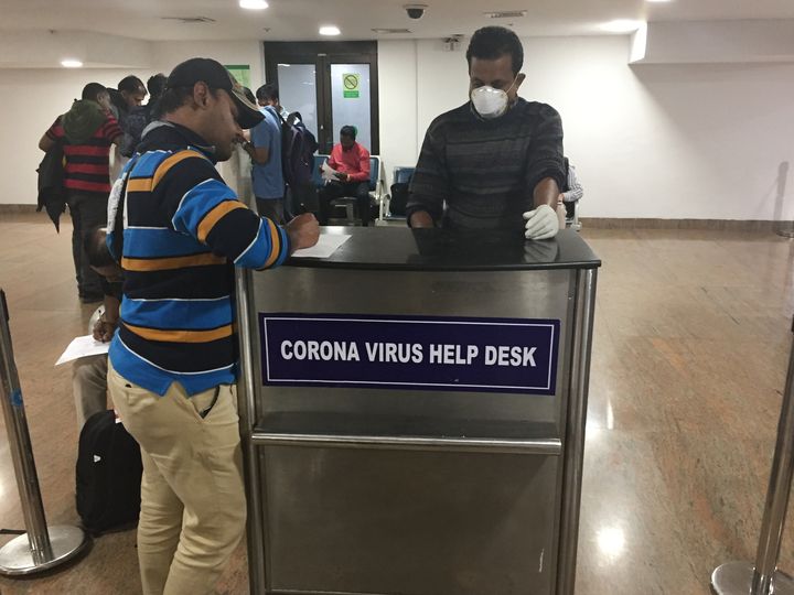 Tourists complete declarations stating they have not recently traveled to China and that they are not experiencing any symptoms of the Wuhan coronavirus at Trivandrum International Airport in Thiruvananthapuram Kerala, on 3 February 2020. 
