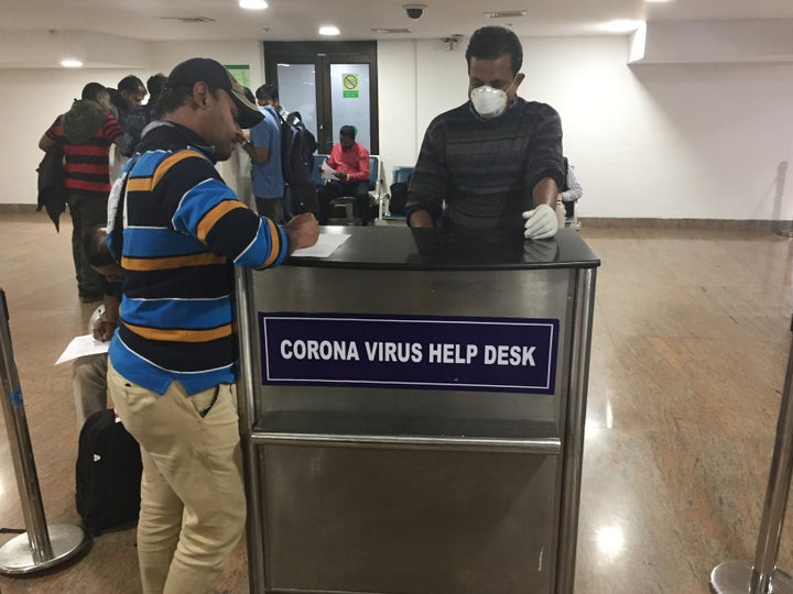 Tourists complete declarations stating they have not recently traveled to China and that they are not experiencing any symptoms of the Wuhan coronavirus at Trivandrum International Airport in Thiruvananthapuram Kerala, on 3 February 2020.