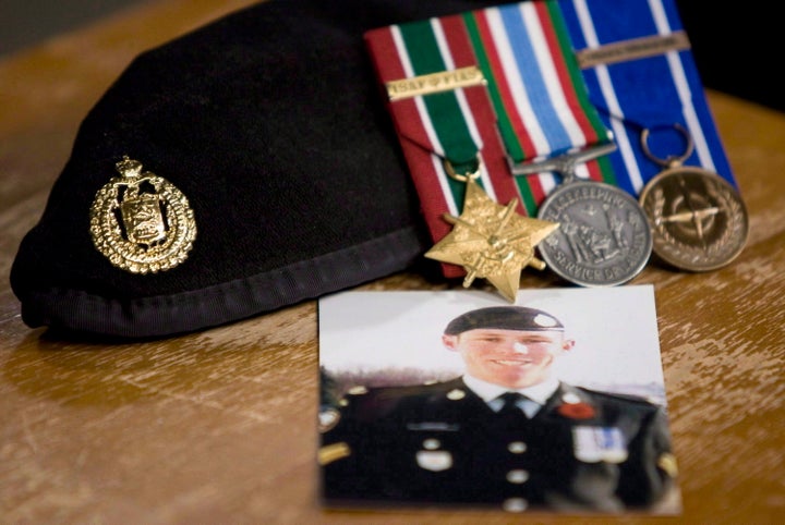 A photo of Cpl. Stuart Langridge is seen along with his beret and medals at a news conference on Parliament Hill on Oct. 28, 2010. 