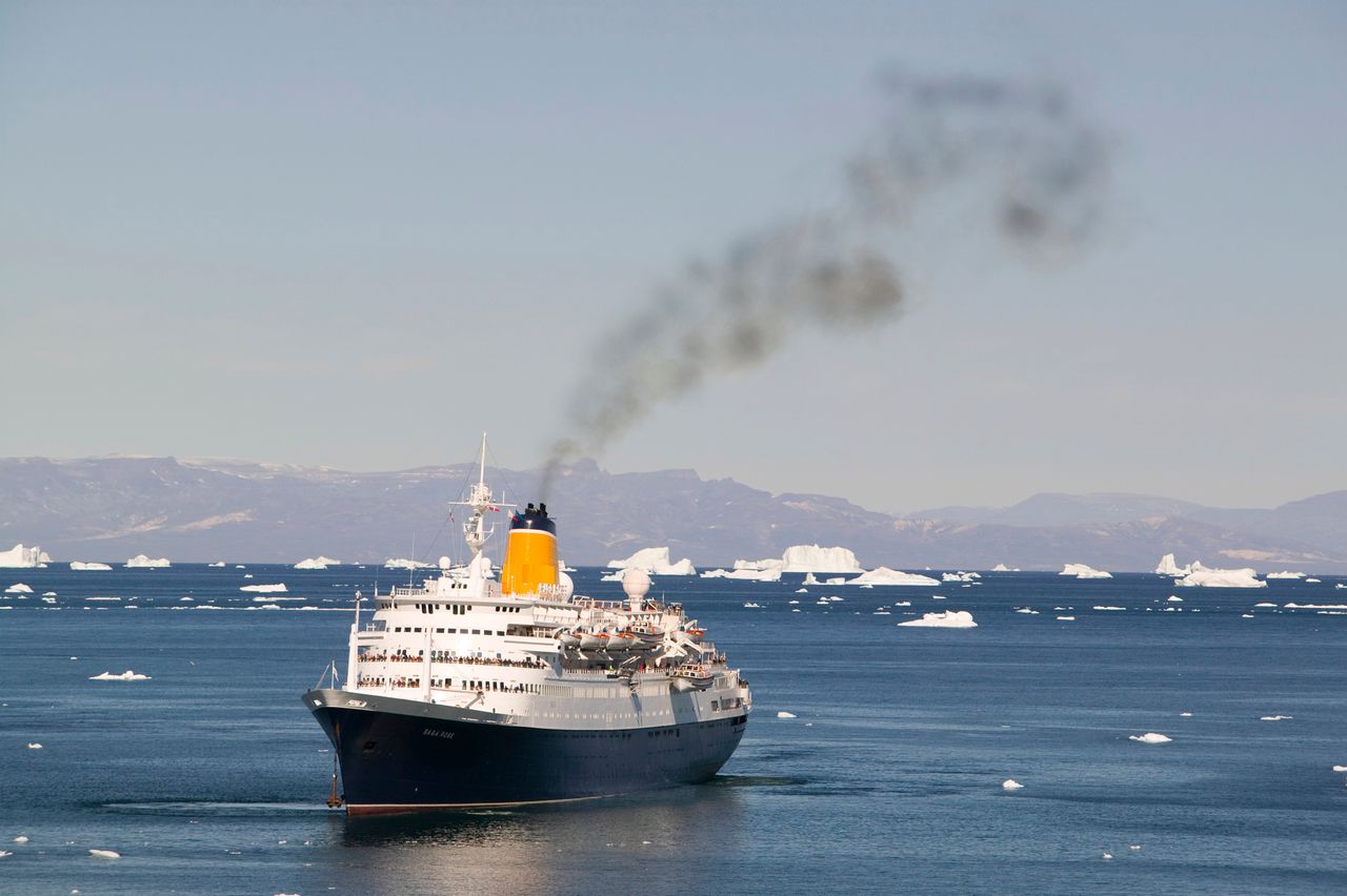 A cruise ship off Ilulissat on Greenland, which is a UNESCO World Heritage Site because of the Jacobshavn Glacier or Sermeq Kujalleq, the largest glacier outside Antarctica.