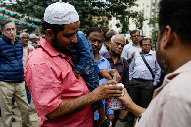 Supporters of Communist Party of India-Marxist (CPI-M) collect funds for victims affected during the...