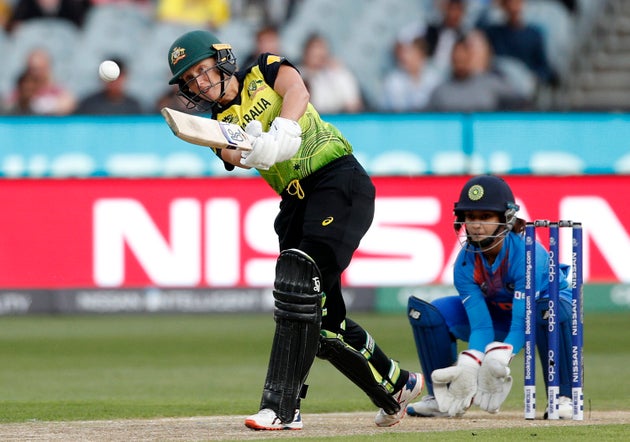 Australia's Alyssa Healy, left, drives the ball in front of IndiaÅfs Tanya Bhatia during the WomenÅfs...