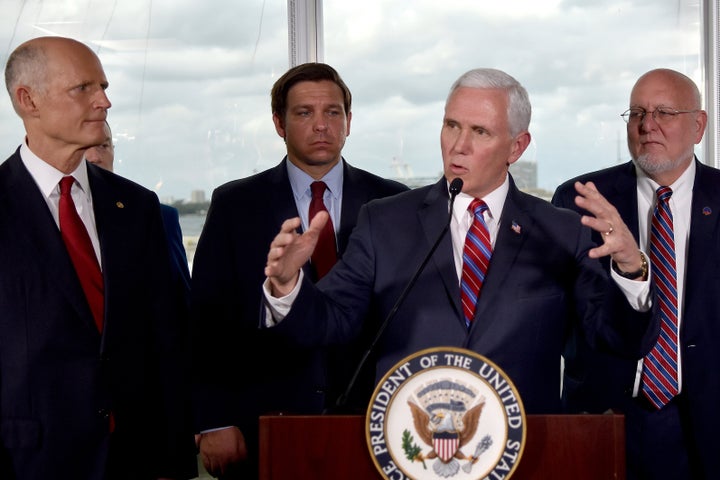 Vice President Mike Pence, center, along with Florida Sen. Rick Scott, far left, and Gov. Ron DeSantis, left, and CDC Director Dr. Robert Redfield, right, speaks to the media after a meeting with cruise line company leaders to discuss the efforts to fight the spread of the COVID-19 coronavirus, at Port Everglades, Saturday March 7, 2020, in Fort Lauderdale, Fla.