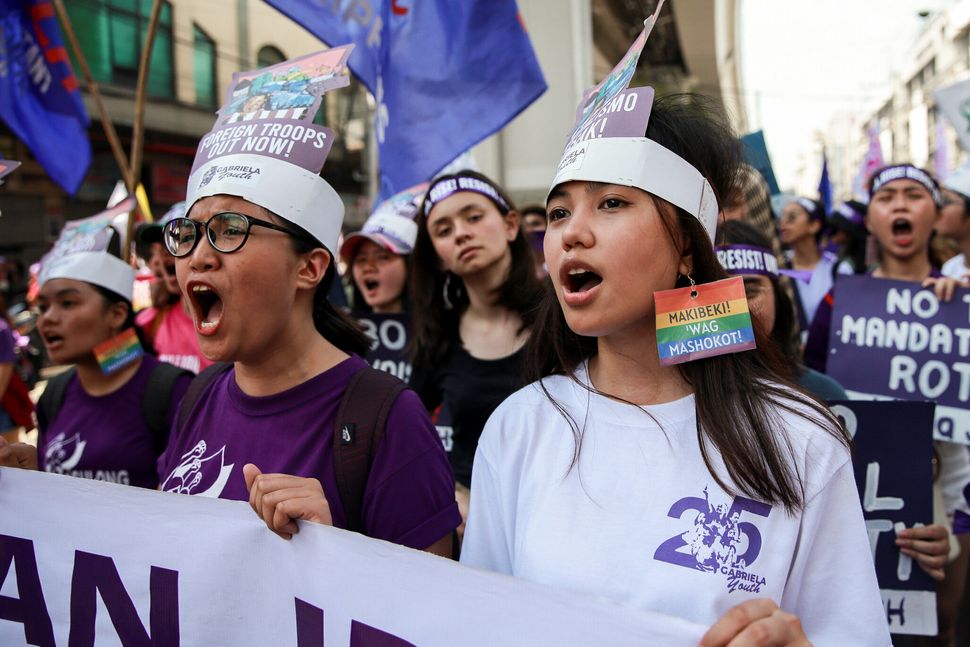 Women's rights activists shout slogans during a protest Manila, Philippines.