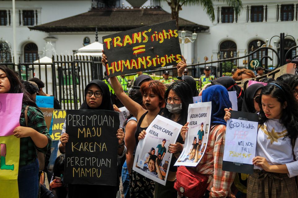 Protesters hold placards during a protest in Bandung, Indonesia. 