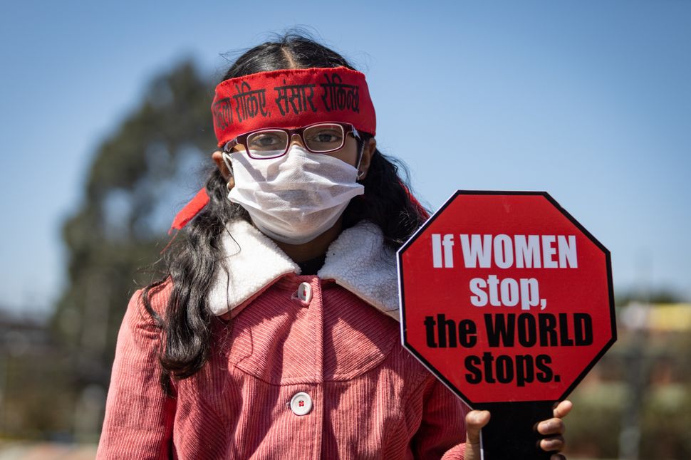 KATHMANDU, NEPAL - 2020/03/08: A woman holds a placard during a protest against gender inequality and sexual violence in Kathmandu, Nepal. 