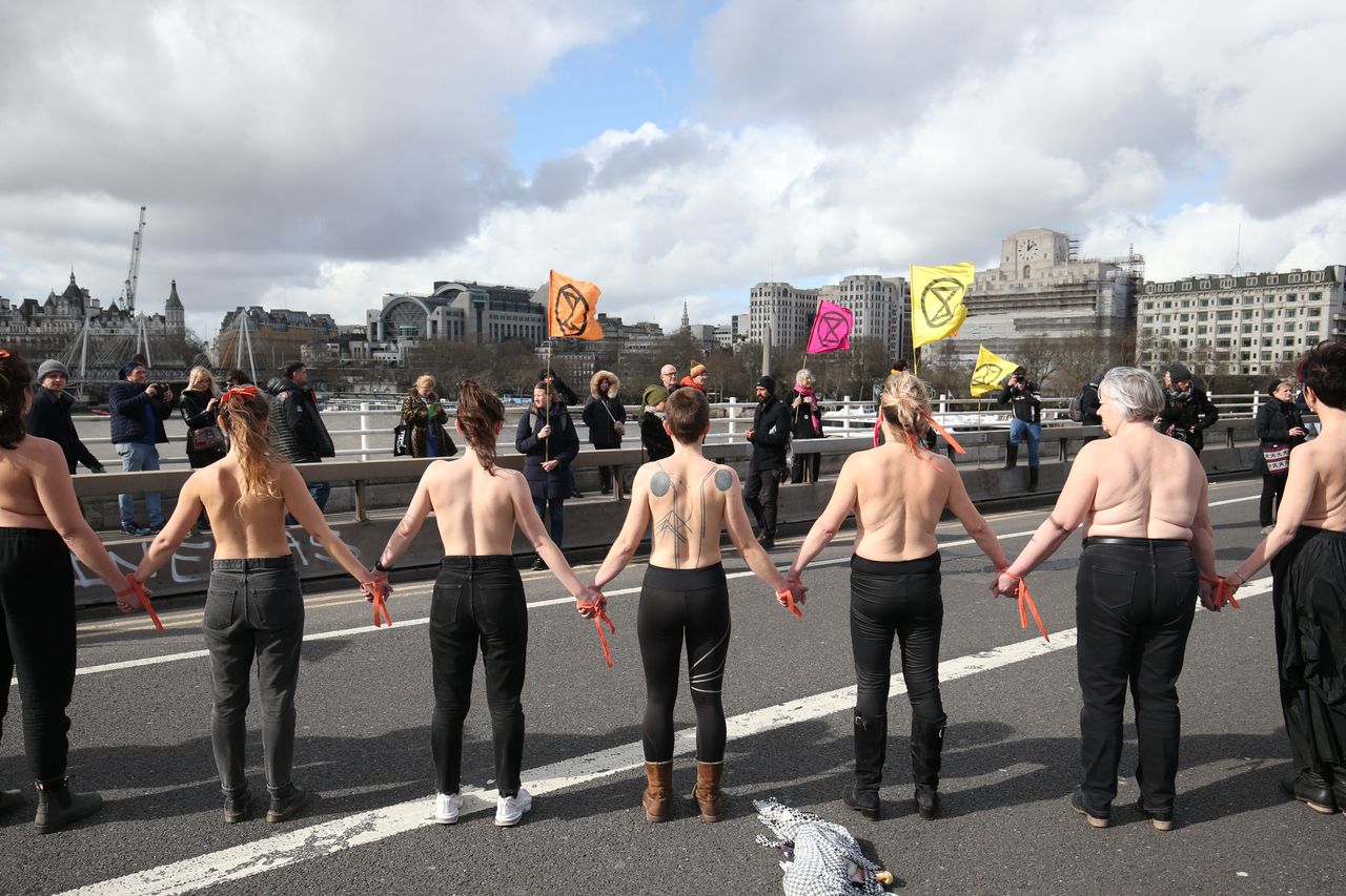 31 women from Extinction Rebellion form a topless protest chain on Waterloo Bridge.