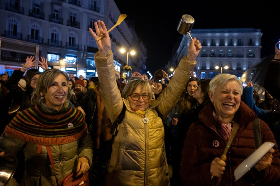 Women making noise hitting pots and pans protesting in Sol Square, Madrid, Spain. to mark the start of the International Women's Day.