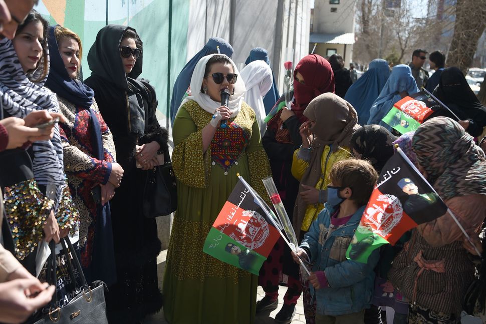 Afghan civil activists gather along a road in Kabul.