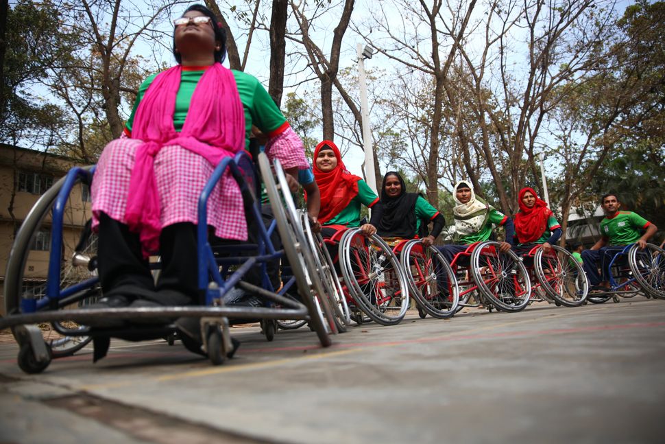 Disabled Bangladeshi women play basketball during a match in Savar on the outskirts of Dhaka. 