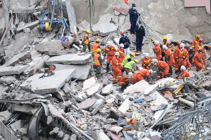 In this photo released by Xinhua News Agency, rescuers search for victims at the site of a hotel collapse in Quanzhou, southeast China's Fujian Province, Sunday, March 8, 2020.