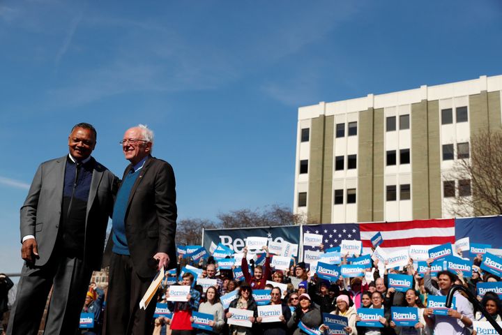 Civil rights activist Rev. Jesse Jackson stands on stage after endorsing presidential candidate Bernie Sanders at a rally in Grand Rapids, Michigan, on Sunday.