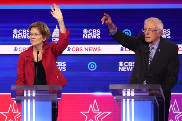 Sen. Elizabeth Warren (D-Mass.), left, and Sen. Bernie Sanders (I-Vt.) appear on the debate stage in Charleston, S.C. Some of Warren's liberal supporters are backing Sanders.