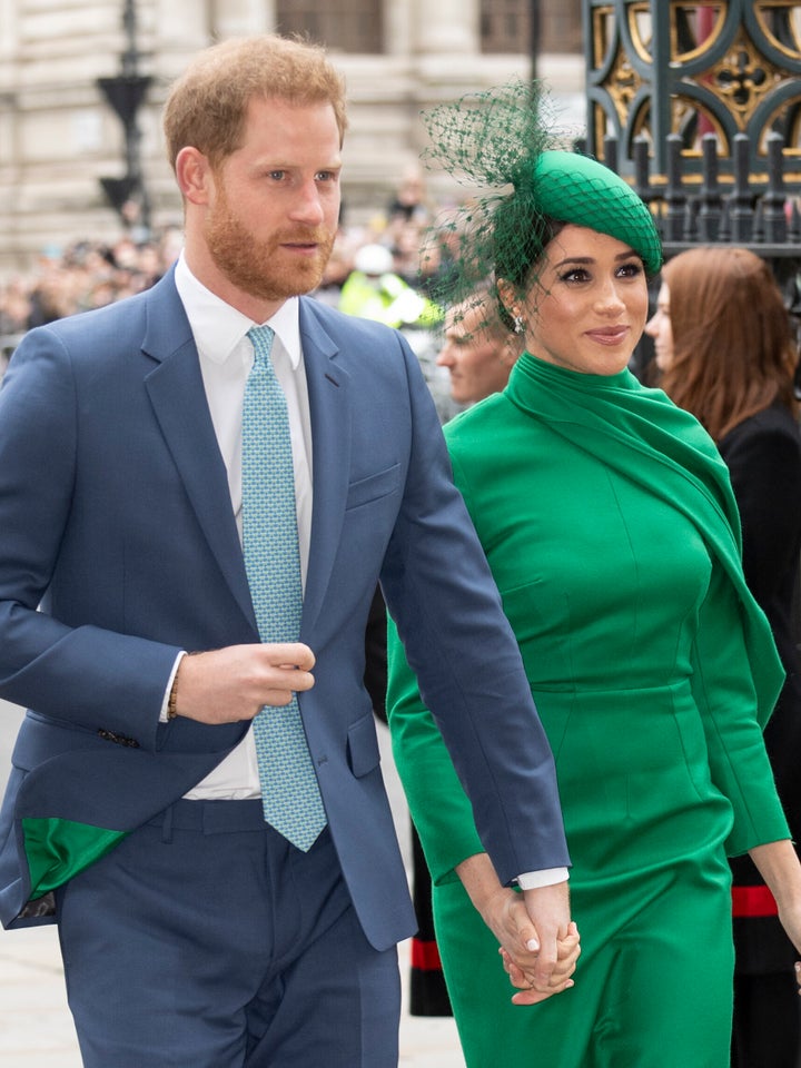 The lining of Harry's suit is green, matching Meghan's ensemble.