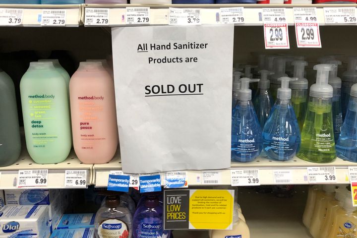 A sign on a shelf at a grocery store in Kirkland, Wash., advises shoppers on March 3 that all hand sanitizer products are sold out. Fear of the coronavirus has led people to stock up on the germ-killing gel, leaving store shelves empty and online retailers with sky-high prices set by those trying to profit on the rush.