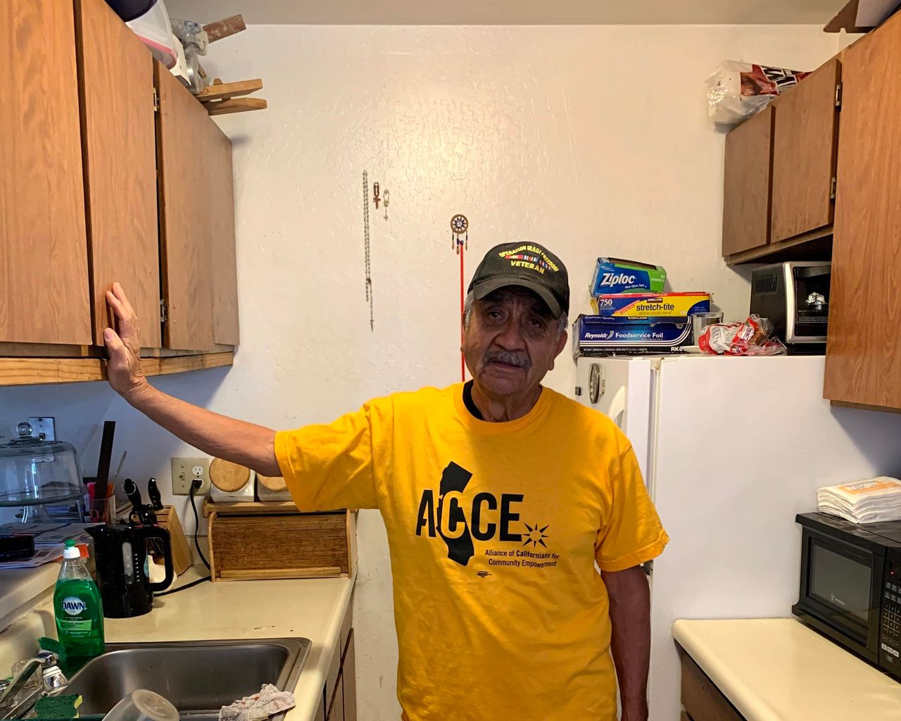 Francisco Perez stands in the kitchen of his Oakland apartment. He is on rent strike to protest the poor conditions of his home and the steeply increasing rents.