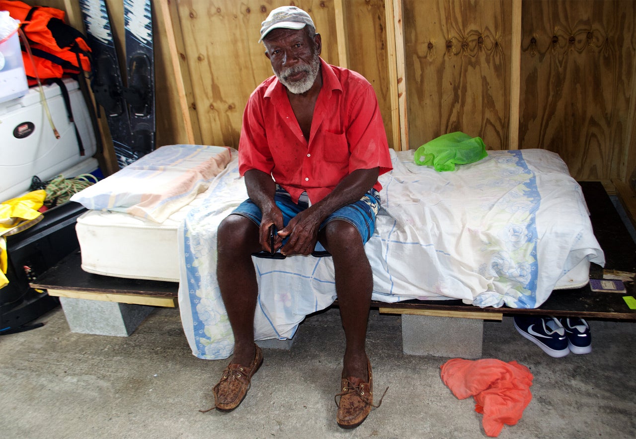 George Jeffery sits in the one-room wooden cottage he just finished building with the help of friends and some supplies given to him by the NGO Samaritan’s Purse. He has slept on a crooked lawn chair in tattered tents for over two years.