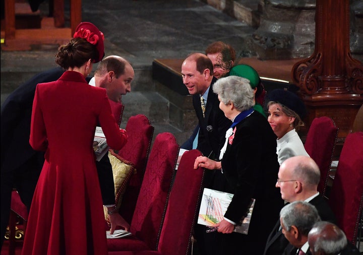 Prince William and Prince Edward appear to exchange greetings.