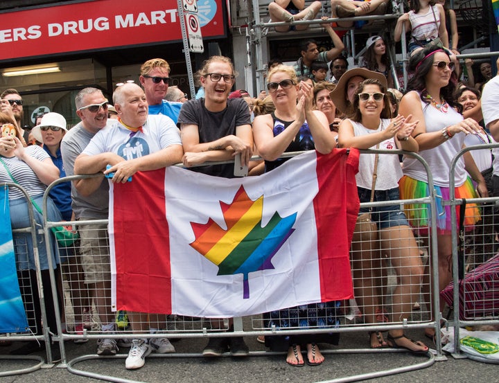 File photo of Canada's flag with a maple leaf full of rainbow colours.