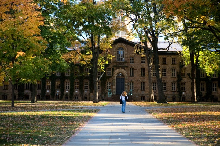 A student walks toward Princeton University's Nassau Hall. The college plans to begin "virtual instruction" starting March 23.