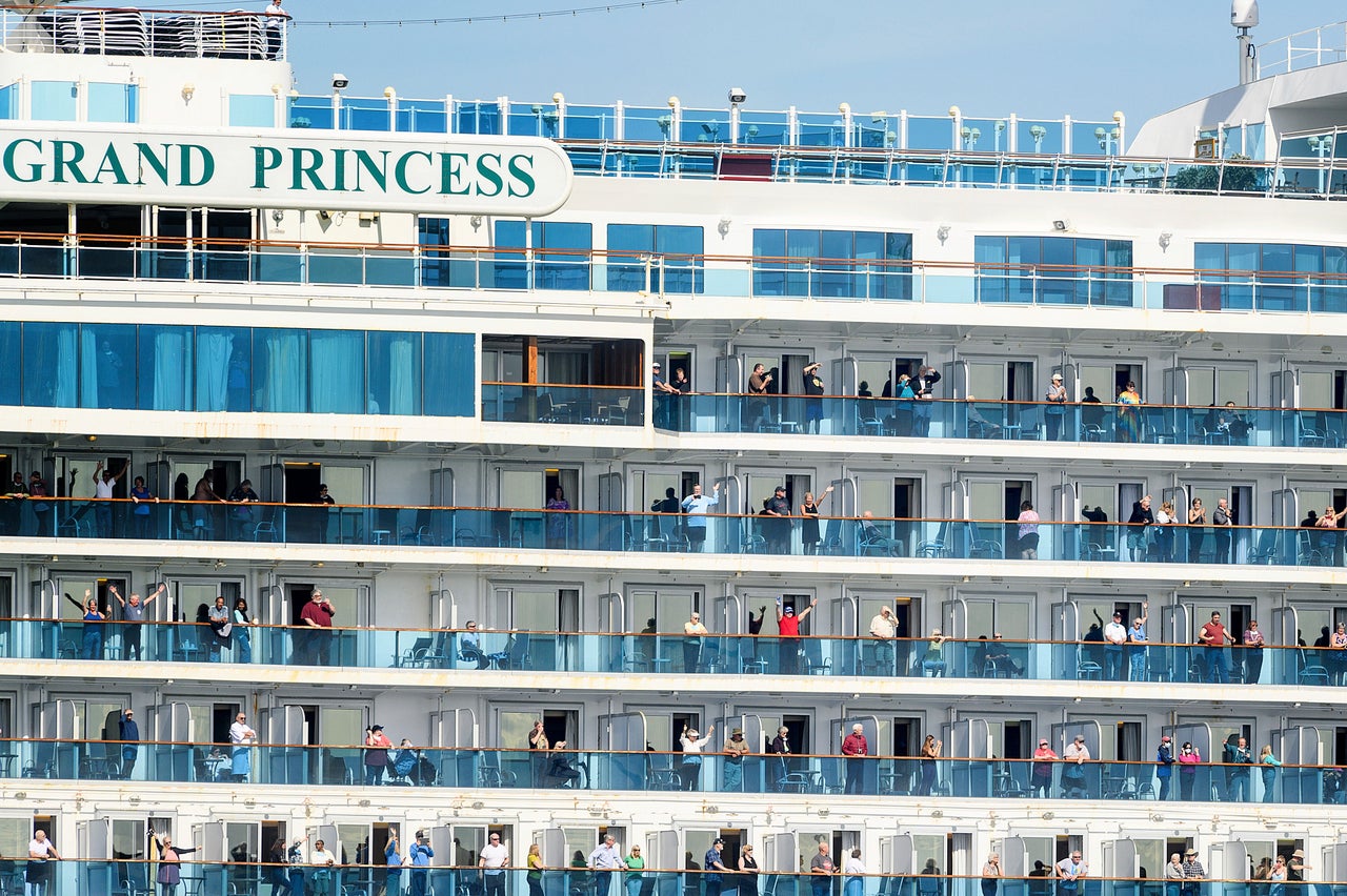 Passengers aboard the Grand Princess celebrate as they arrive in Oakland, California 