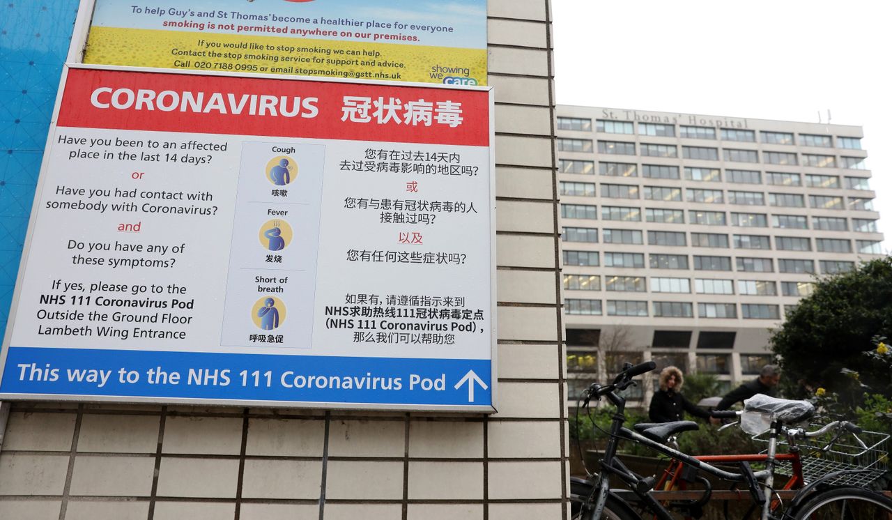 A sign directs patients towards an NHS 111 Coronavirus Pod at St Thomas' Hospital in London 