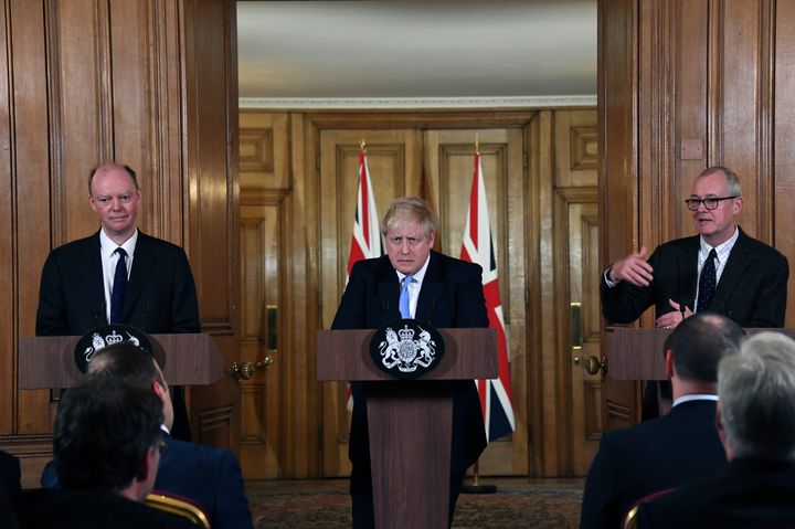 From left, Chief Medical Officer for England Chris Witty, Britain's Prime Minister Boris Johnson and Chief Scientific Adviser Patrick Vallance speak during a press conference about coronavirus in 10 Downing Street in London, Monday, March 9, 2020. (AP Photo/Alberto Pezzali)