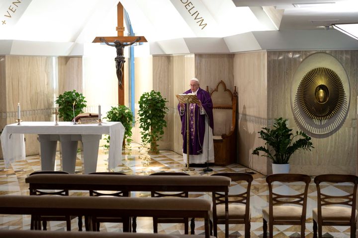 Pope Francis leads Mass via a video livestream in a chapel full of empty seats as part of measures to combat the spread of co