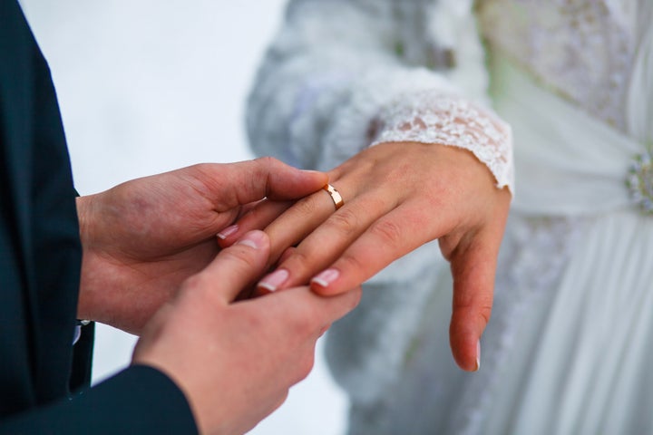 hands of bride groom ring close ...