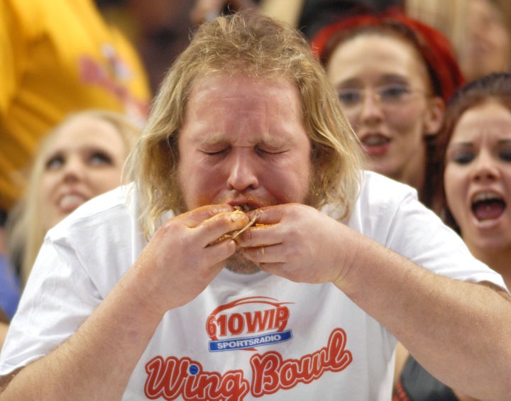 PHILADELPHIA - JANUARY 30: Douglas 'Obi WIng' Petock stuffs his mouth with Buffalo Wings during Wing Bowl 17 at the Wachovia Center January 30, 2009 in Philadelphia, Pennsylvania. Thousands attended the event to witness John 'Super Squib' Squib eat 203 Buffalo Wings to win Wing Bowl 17. Wing Bowl started as an alternative to the Super Bowl by a Philadelphia radio host who was tired of the Eagles never making it to the big Game. (Photo by William Thomas Cain/Getty Images)